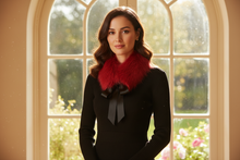 Load image into Gallery viewer, Woman wearing a black outfit with a red scarf in front of a large window with a garden view.