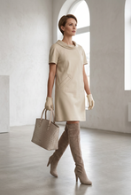 Įkelti nuotrauką į galerijos peržiūros programą, Beige Vilniaus Kailiai dress with sleeveless design, featuring a stylish and comfortable fit perfect for casual or formal wear.
