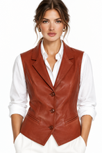 Įkelti nuotrauką į galerijos peržiūros programą, A woman wearing a fitted brown faux-leather blazer vest over a white collared shirt and white trousers, photographed against a clean white studio background.