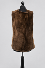 Load image into Gallery viewer, A sleeveless brown faux fur vest displayed on a black dress form mannequin against a light gray studio background.