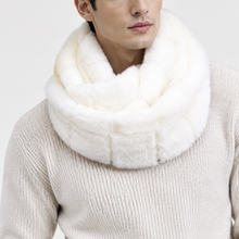 Įkelti nuotrauką į galerijos peržiūros programą, A man wearing a thick, plush white faux-fur double-neck scarf and a cream-colored ribbed knit sweater, photographed against a clean, light gray studio background.
