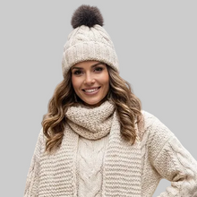 Įkelti nuotrauką į galerijos peržiūros programą, Stylish woman wearing Vilniaus Kailiai Mod. PAULINA hat, a fashionable accessory with a cozy, textured design.