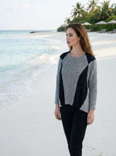 Load image into Gallery viewer, Woman wearing a black and gray patterned top on a beach