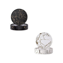 Load image into Gallery viewer, A set of two round PU leather coasters, one black and one white, with a marble-like pattern, displayed with and without a holder.