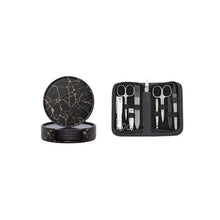 Load image into Gallery viewer, A set of round PU leather coasters with a marble-like pattern, displayed next to a black case containing a set of nail care tools.