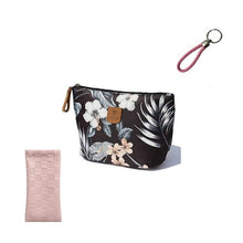 Load image into Gallery viewer, A black floral-patterned PU leather squeeze case for glasses with a colorful leather key holder and a pink textile cosmetic bag, plus a pink floral-patterned textile with a key holder.
