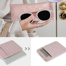 Load image into Gallery viewer, A pink textile laptop case with a quilted design and a separate eyewear case, held in a person's hand. The laptop case has a zipper closure, and the eyewear case has a similar design with a mirror.