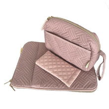 Load image into Gallery viewer, A pink textile cosmetic case with a quilted design, opened to show the interior which includes a second compartment, against a white background.