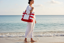 Load image into Gallery viewer, Woman holding a red and white bag on a beach