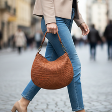 Load image into Gallery viewer, Person walking on a street holding a brown woven handbag