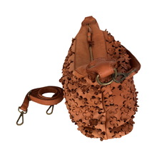 Load image into Gallery viewer, Brown leather bag with intricate cut-out designs on a white background