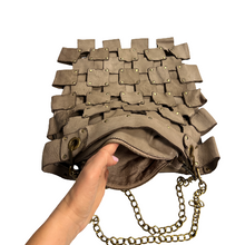 Load image into Gallery viewer, Handbag with unique design held by a hand on a white background