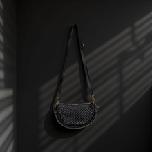Load image into Gallery viewer, Black woven handbag on a dark background
