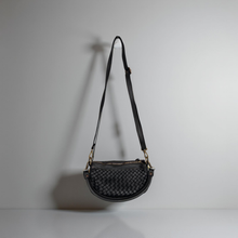 Load image into Gallery viewer, Black woven handbag with a strap on a light gray background