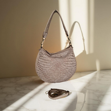 Load image into Gallery viewer, Woven handbag on a marble surface with soft lighting