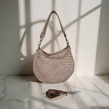 Load image into Gallery viewer, Woven handbag on a marble surface with soft lighting