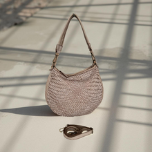 Load image into Gallery viewer, Woven handbag on a textured surface with shadows
