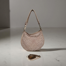 Load image into Gallery viewer, Woven handbag on a reflective surface with a neutral background