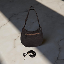 Load image into Gallery viewer, Brown handbag with a strap on a marble surface