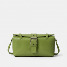 Įkelti nuotrauką į galerijos peržiūros programą, A sage green leather shoulder bag with a structured rectangular shape, a front flap closure featuring a silver-tone buckle, and a matching green strap, shown against a plain light gray background.