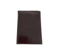 Load image into Gallery viewer, A closed black leather wallet with the brand name embossed on the front.