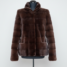 Įkelti nuotrauką į galerijos peržiūros programą, A dark brown mottled faux fur jacket with a high collar and horizontal quilted paneling, displayed on a black mannequin torso against a light gray background.