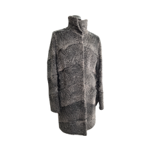 Load image into Gallery viewer, A dark grey astrakhan knee-length coat with pockets at the front and a fur hooks fastening. The coat has a regular collar and is displayed on a mannequin.