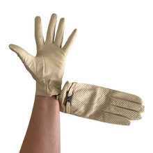 Load image into Gallery viewer, A single white glove designed for women, made of perforated leather with a decorative metal element on the wrist.