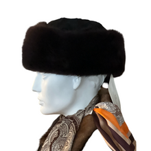 Load image into Gallery viewer, A round fur cap made of bluefox and astrakhan fur with a textile lining, displayed on a mannequin.