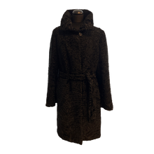 Load image into Gallery viewer, A black Astrakhan fur coat with a classic collar, front pockets, and fur hooks fastening. It has a straight silhouette and falls just below the knee with a tie at the waist.