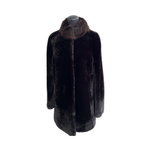 Load image into Gallery viewer, A long black sheepskin fur coat with a pink silver fox fur collar, displayed on a mannequin.