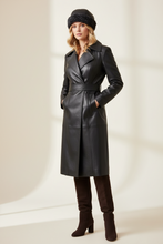 Load image into Gallery viewer, Woman wearing a black leather coat, black boots, and a black hat against a white background