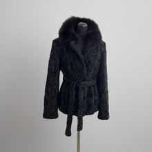 Įkelti nuotrauką į galerijos peržiūros programą, Black astrakhan fur jacket with a black Bluefox collar, featuring front pockets and fur hooks fastening, displayed on a mannequin.