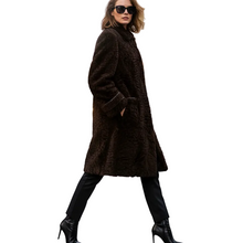 Įkelti nuotrauką į galerijos peržiūros programą, A woman wearing a dark brown textured faux-fur coat, black pants, and black high-heeled boots, walking against a solid white background.