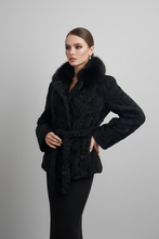 Įkelti nuotrauką į galerijos peržiūros programą, A woman modeling a black textured faux-fur wrap coat with a wide black fur collar, photographed against a plain light gray studio background.
