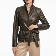 Load image into Gallery viewer, A woman modeling a metallic textured jacket with a stand collar, button front, and matching tie belt, paired with beige trousers against a plain white studio background.