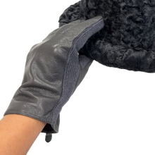 Load image into Gallery viewer, A close-up image of a woman's hand wearing a black Nappa leather glove, with the focus on the glove's texture and fit.