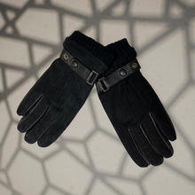 Load image into Gallery viewer, Pair of black gloves with leather straps on a textured surface