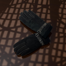 Load image into Gallery viewer, Pair of black gloves with leather straps on a dark background