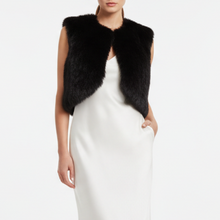 Įkelti nuotrauką į galerijos peržiūros programą, A model wearing a black faux fur cropped vest over a white satin slip dress, shown from the neck down against a plain white studio background.