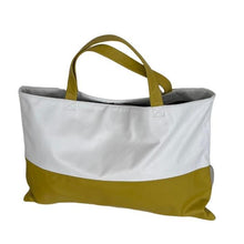 Load image into Gallery viewer, A white and mustard brown leather handbag with no closure and two handles.