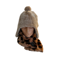 Load image into Gallery viewer, A fur cap made of mouton sheep fur, displayed on a mannequin head, with a visible fur lining and a snap fastener at the back.