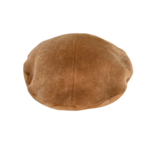 Load image into Gallery viewer, A round beret style sheepskin fur cap in honey brown colour with a visible soft inner lining.