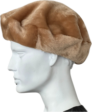 Load image into Gallery viewer, A round beret style sheepskin fur cap in honey brown colour with a visible soft inner lining, on white mannequin head.