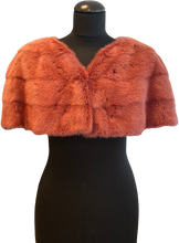 Load image into Gallery viewer, A raspberry  red mink bolero jacket with colourful lining and fur hook fastening at the front on a mannequin.