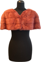 Load image into Gallery viewer, A raspberry  red mink bolero jacket with colourful lining and fur hook fastening at the front on a mannequin.