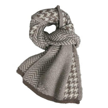 Load image into Gallery viewer, A knitted unisex scarf with a geometric pattern in black and white, displayed in a loop shape.