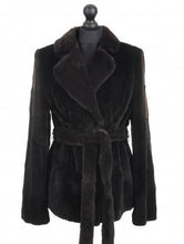 Load image into Gallery viewer, A mahogany dark brown sheared mink jacket with a tie, fur hook fastening, and pockets at the front, displayed on a mannequin.