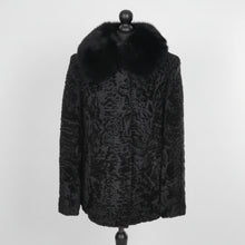 Įkelti nuotrauką į galerijos peržiūros programą, Black astrakhan fur jacket with a mandarin collar and front pockets, displayed on a mannequin.