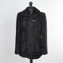 Įkelti nuotrauką į galerijos peržiūros programą, Black astrakhan fur jacket bellow hip length, pockets at sides.